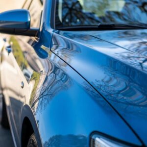 Shiny car under sunlight illustrating the importance of car paint protection against UV damage